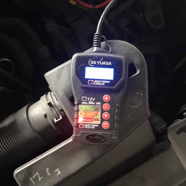Digital battery tester showing a car battery test result