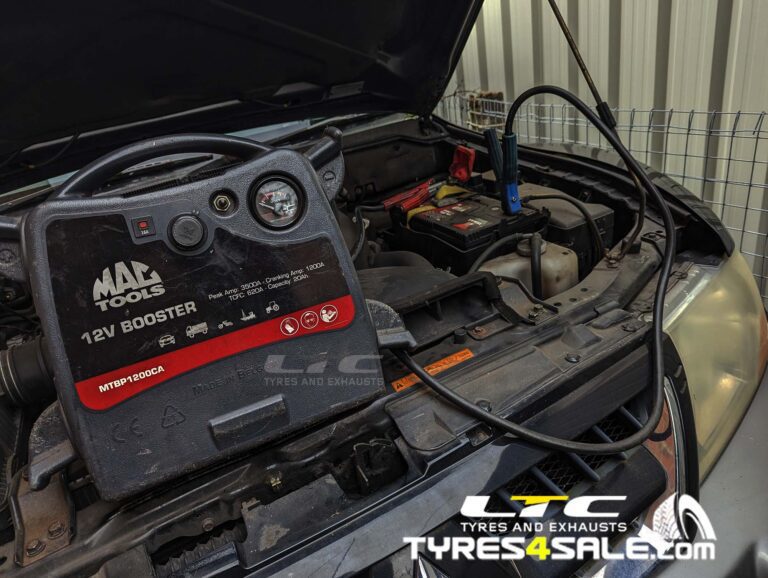 Jump starter pack connected to a car with a flat battery