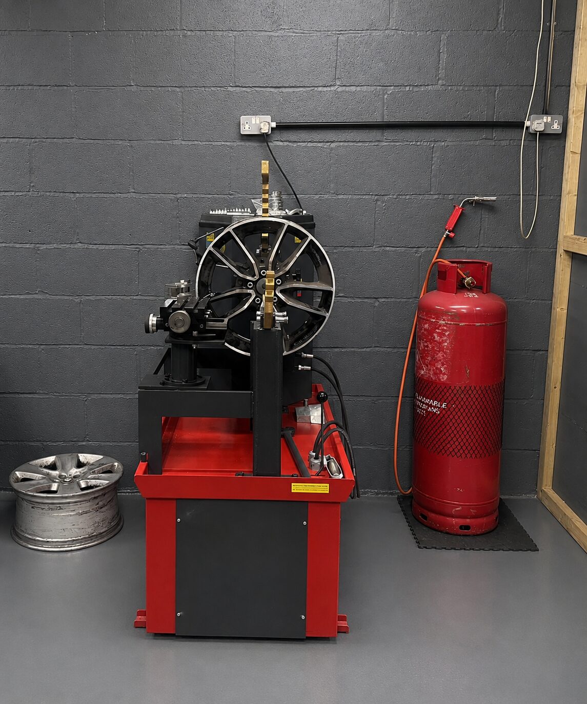 Buckled alloy wheel mounted on specialist straightening equipment at LTC Stourbridge