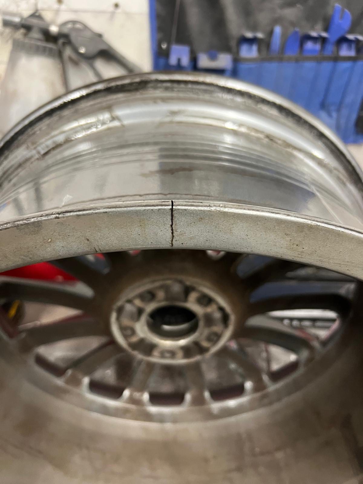 Cracked McLaren alloy wheel after pothole damage
