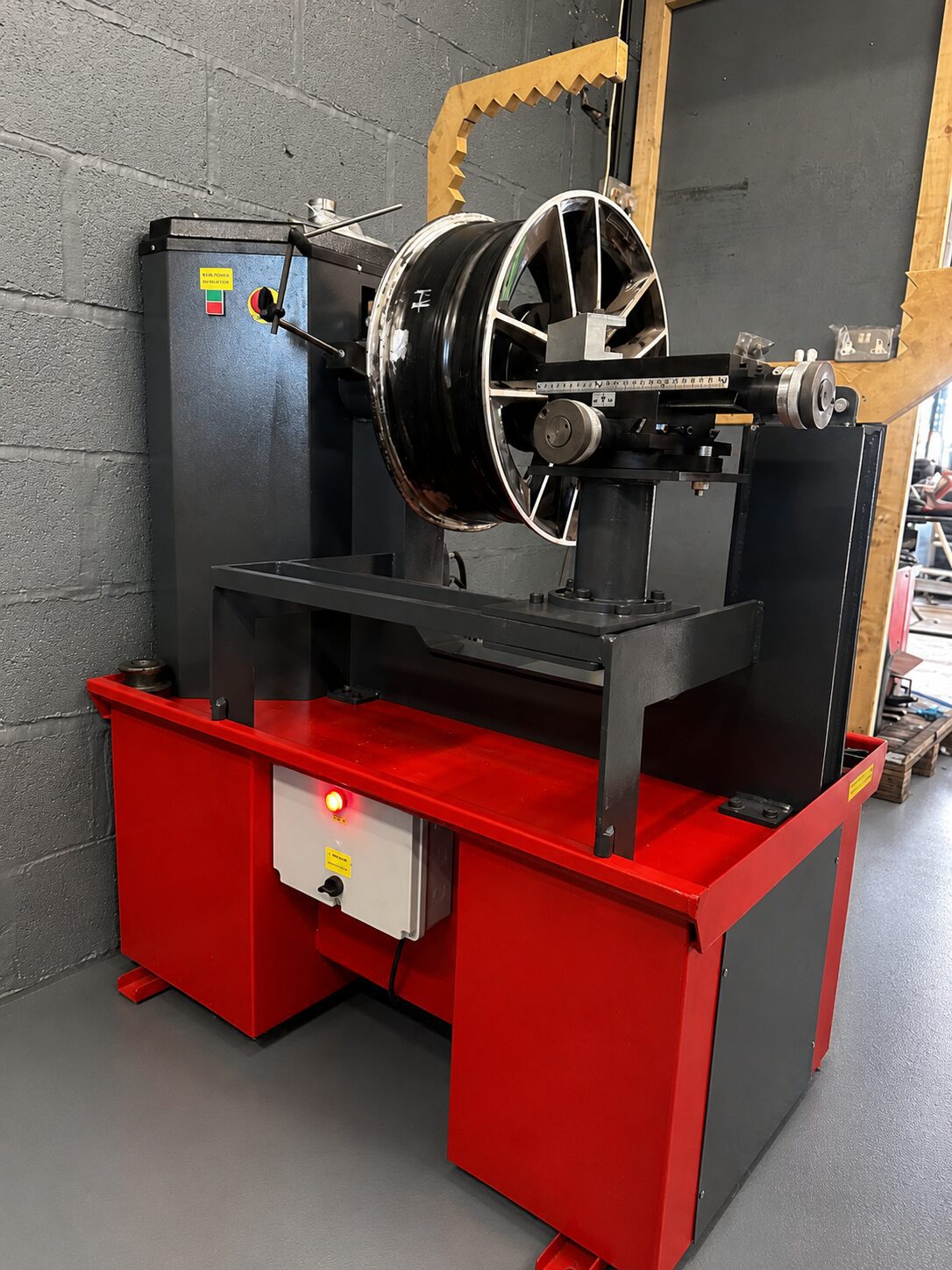 Alloy wheel straightening machine used for buckle repairs at LTC Tyres and Exhausts Stourbridge