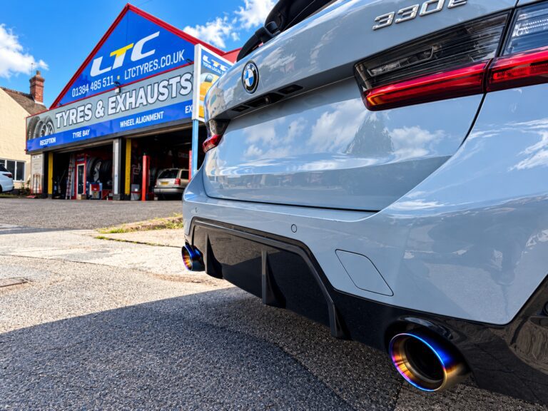 BMW 330e with twin exhaust tailpipes outside LTC Tyres and Exhausts in Brierley Hill