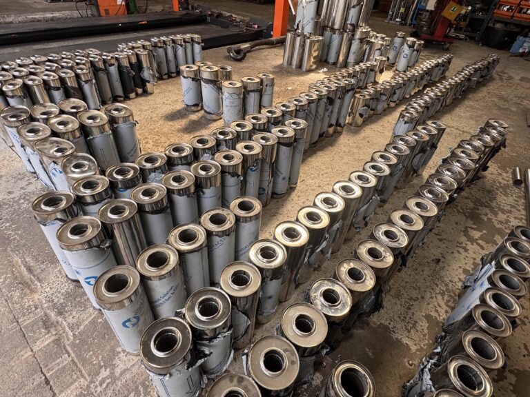 Rows of stainless steel exhaust silencers for Proflow trade and wholesale supply
